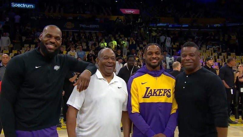Le Bron and Bronny James share a moment with Ken Griffey Sr and Jr before first game